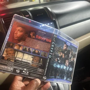 Hands inserting a custom "Die Hard Quadrilogy" cover art into the clear outer sleeve of a transparent USB storage case.